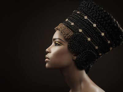 Egyptian woman in dark headdress on black background